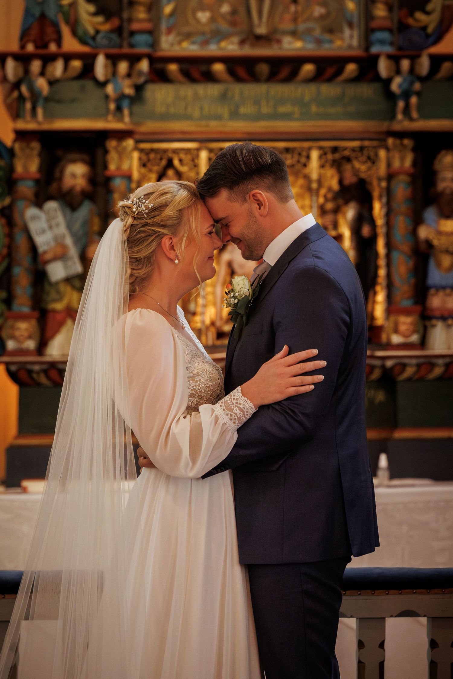A bride and groom share an intimate moment during their church wedding ceremony.