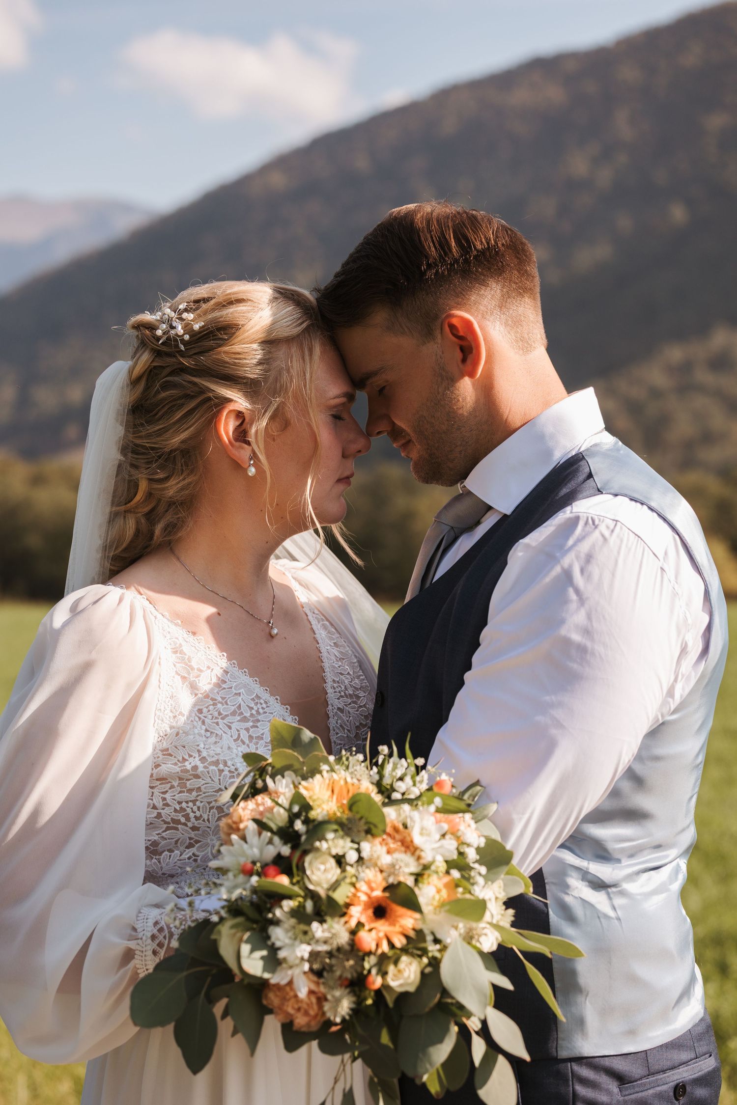 A romantic series of wedding photos showing a couple embracing with mountains in the background and floral bouquet details.
