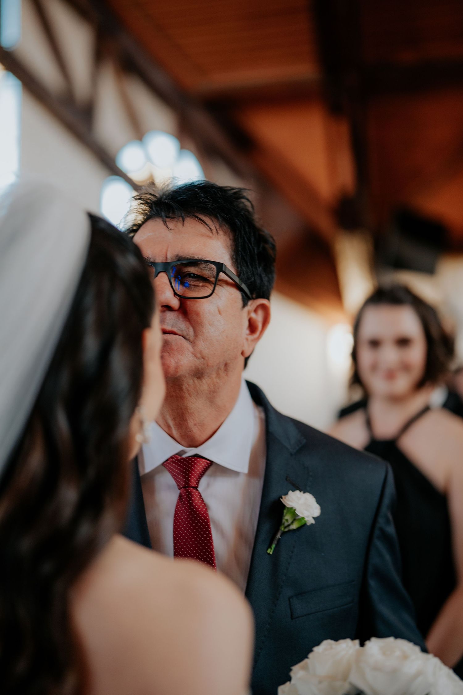 Wedding guest emotions captured during indoor ceremony.