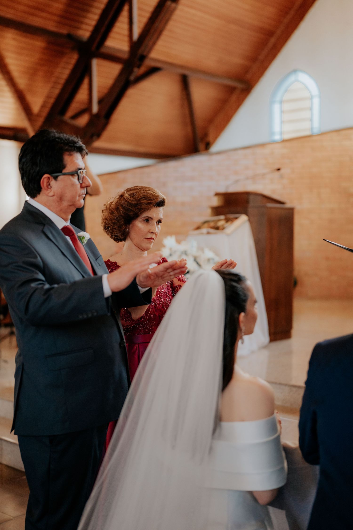 Wedding guests applauding during an indoor church ceremony.