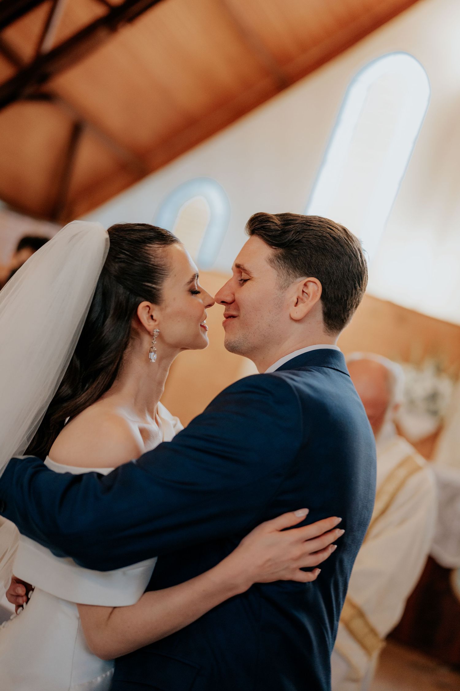 Intimate moment between newlyweds during their wedding ceremony in a church.