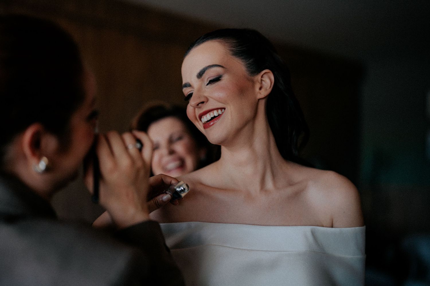 Joyful moments shared during bridal preparations in an intimate setting.