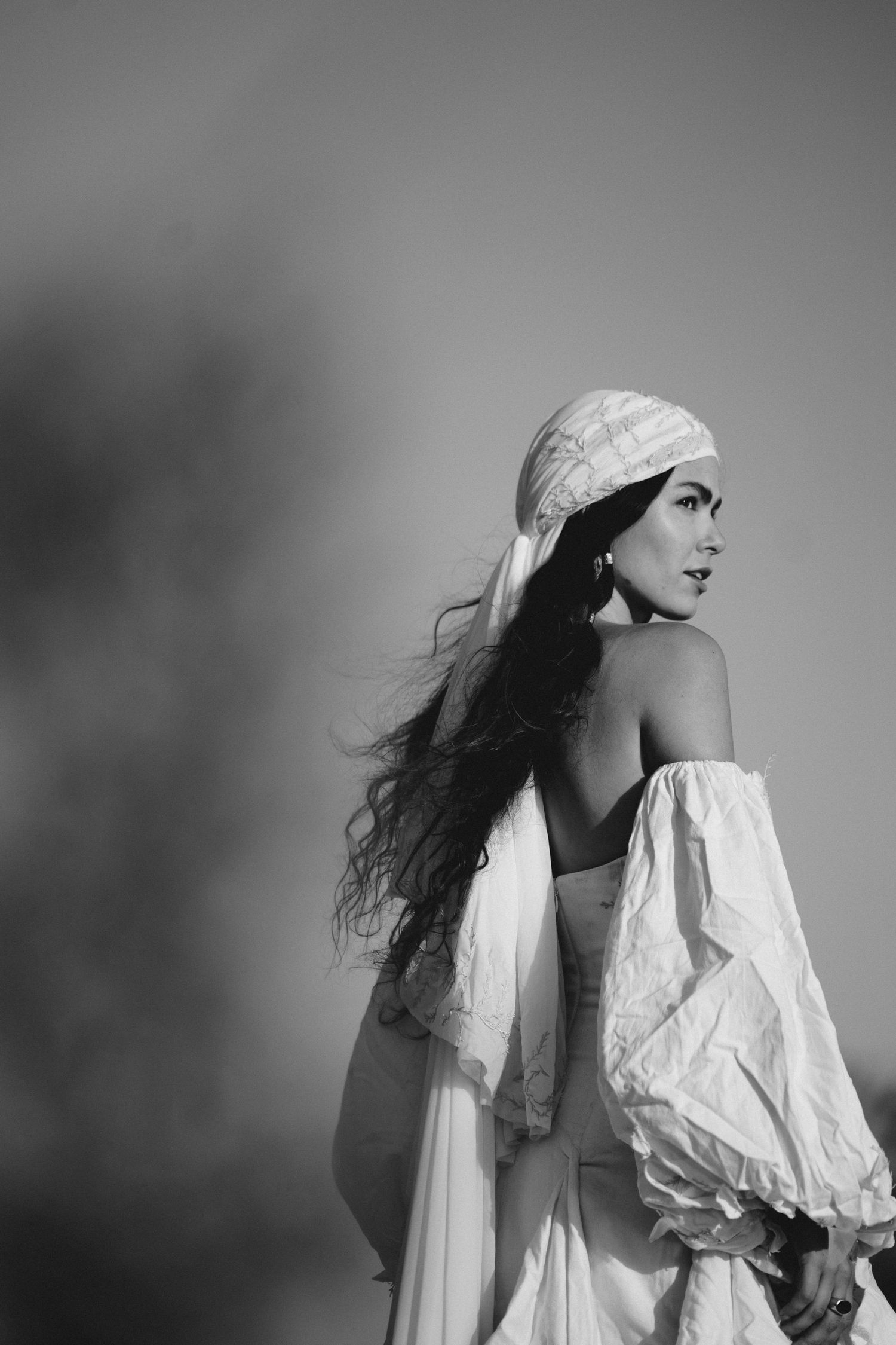 Artistic black and white portrait featuring billowing white fabric and flowing movement.