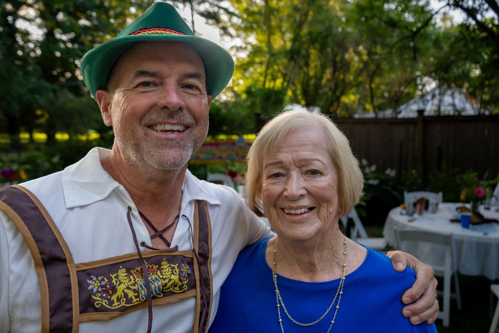 close up portrait of two adults at an outdoor gathering