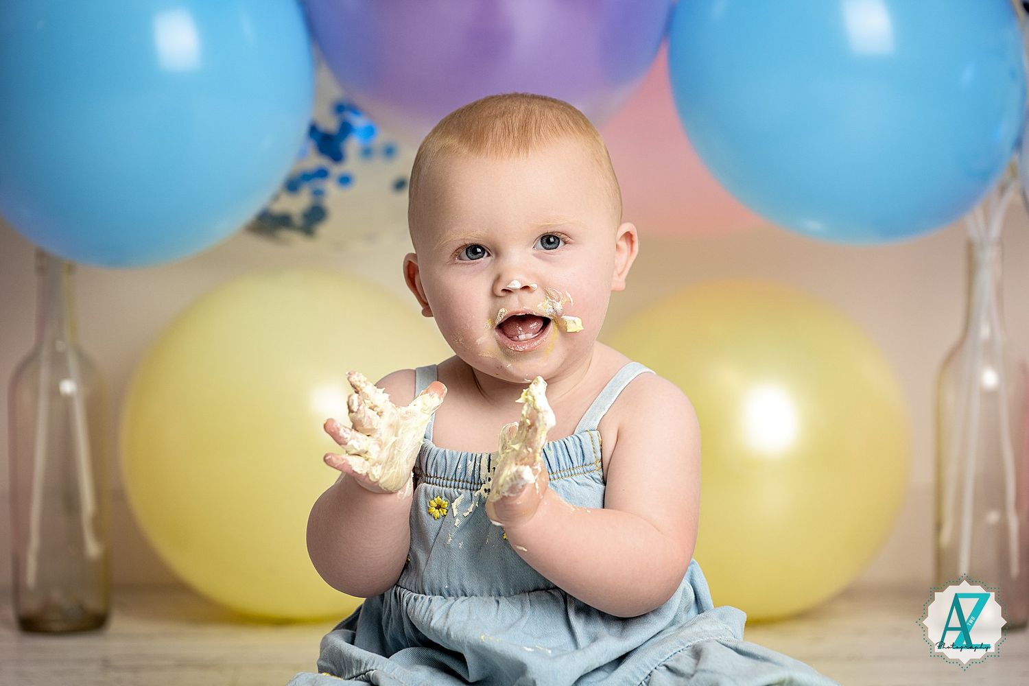 Colorful balloon backdrop with yellow, blue, and purple balloons for birthday photo session.