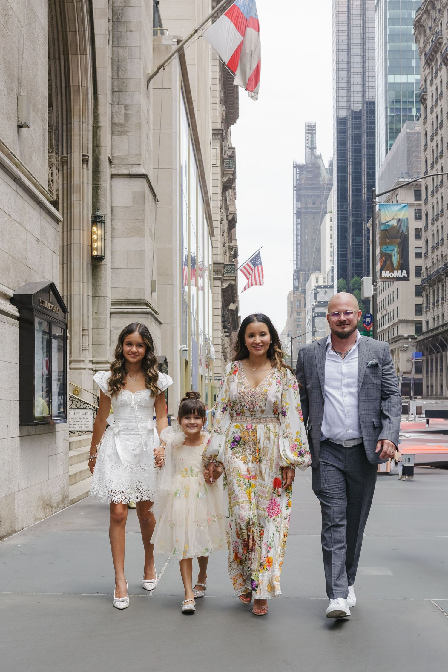 Family strolling down Fifth Avenue after baptism, NYC photo by Paula Brearley