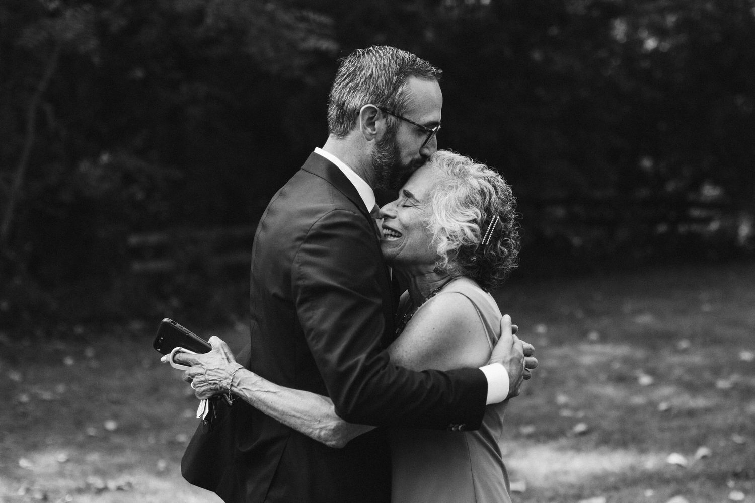 Two people embrace during a romantic outdoor wedding photoshoot.