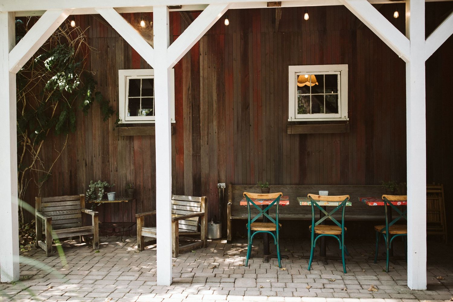 Interior view of rustic wooden barn venue with white support beams.