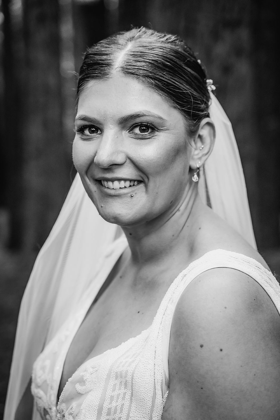 A series of black and white portraits showing joyful expressions during a bride's wedding photoshoot.