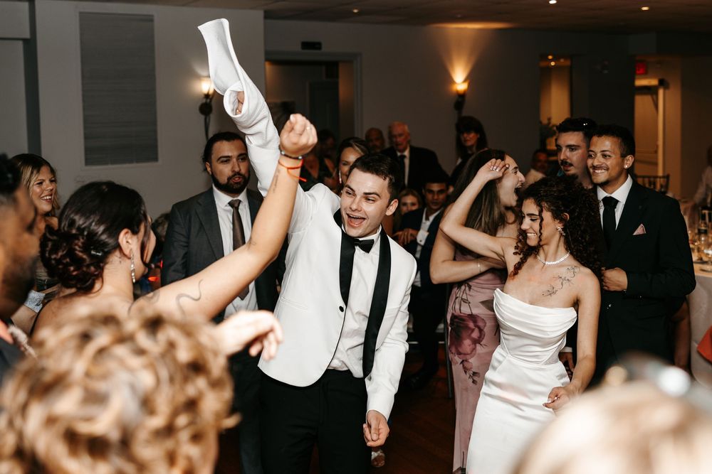 A collage of people dancing and celebrating at a wedding reception in an elegant indoor venue with warm lighting.