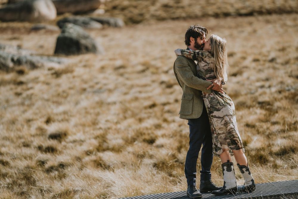 A series of romantic engagement photos showing a couple embracing in a golden field during sunset.