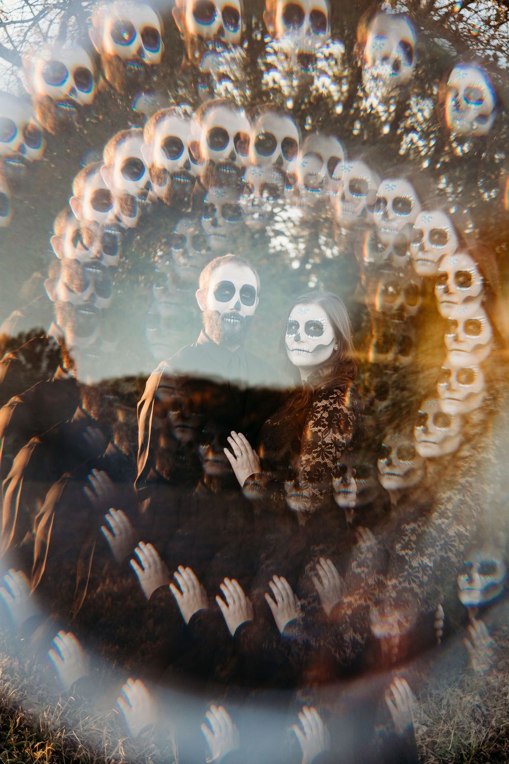 Surreal double exposure of people in skull face paint surrounded by floating skulls in a dark forest setting.