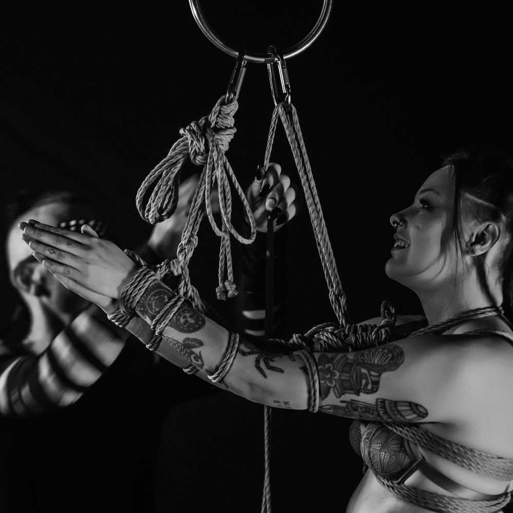 Artistic black and white photo sequence showing necklace and jewelry details in dramatic lighting.