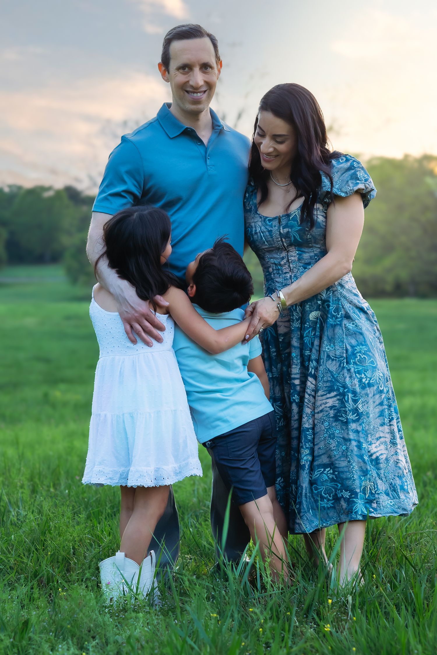 Family of 4 hugging and laughing during family photography session in Athens, GA