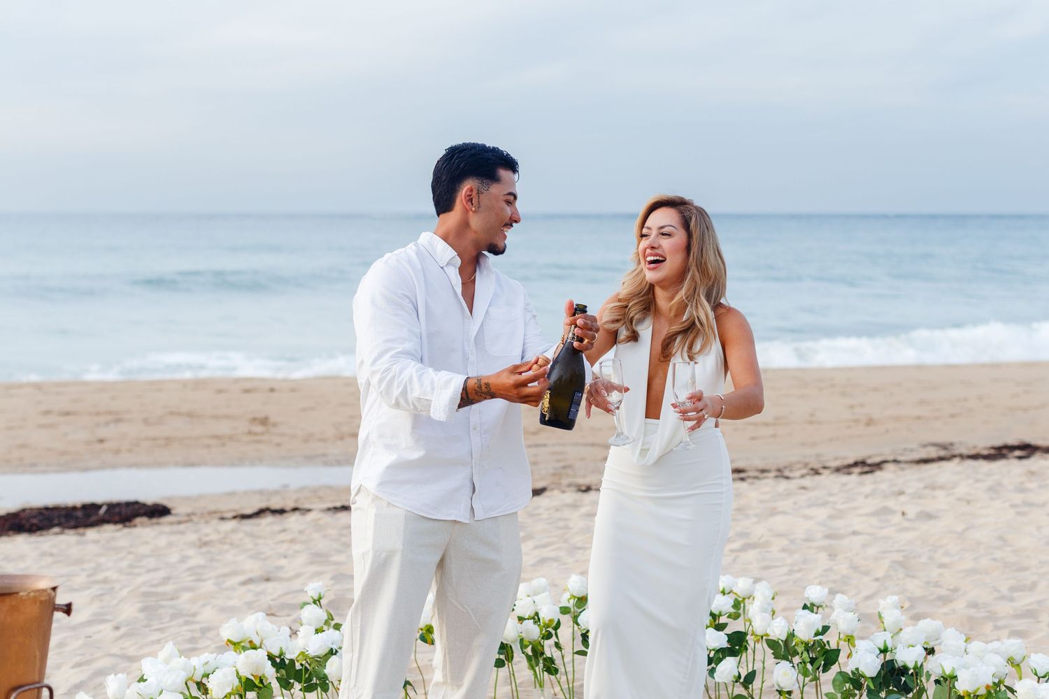 Couples portrait on the beach. Marriage proposal. Opening champagne. San Juan, Puerto Rico.