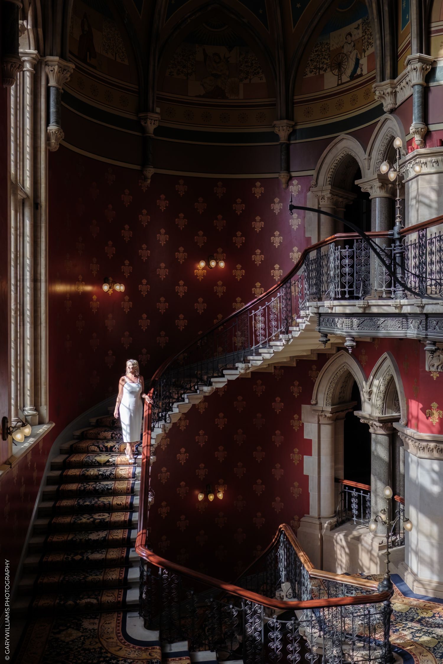 Old abandoned theater staircase with ornate architecture and dramatic lighting creates an eerie atmosphere.