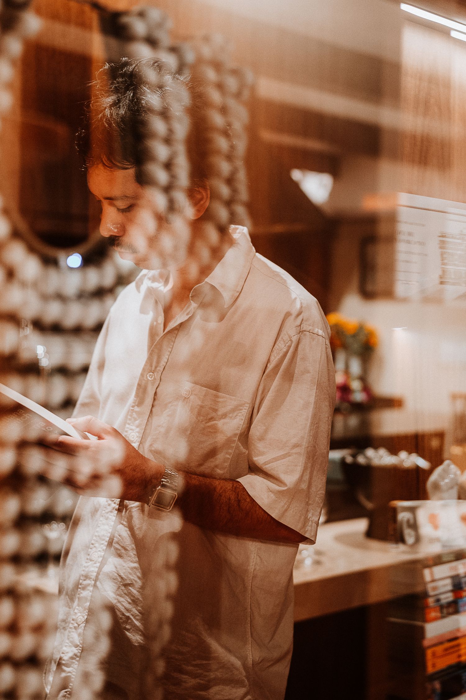 Warm-toned image of person reading document in indoor setting.