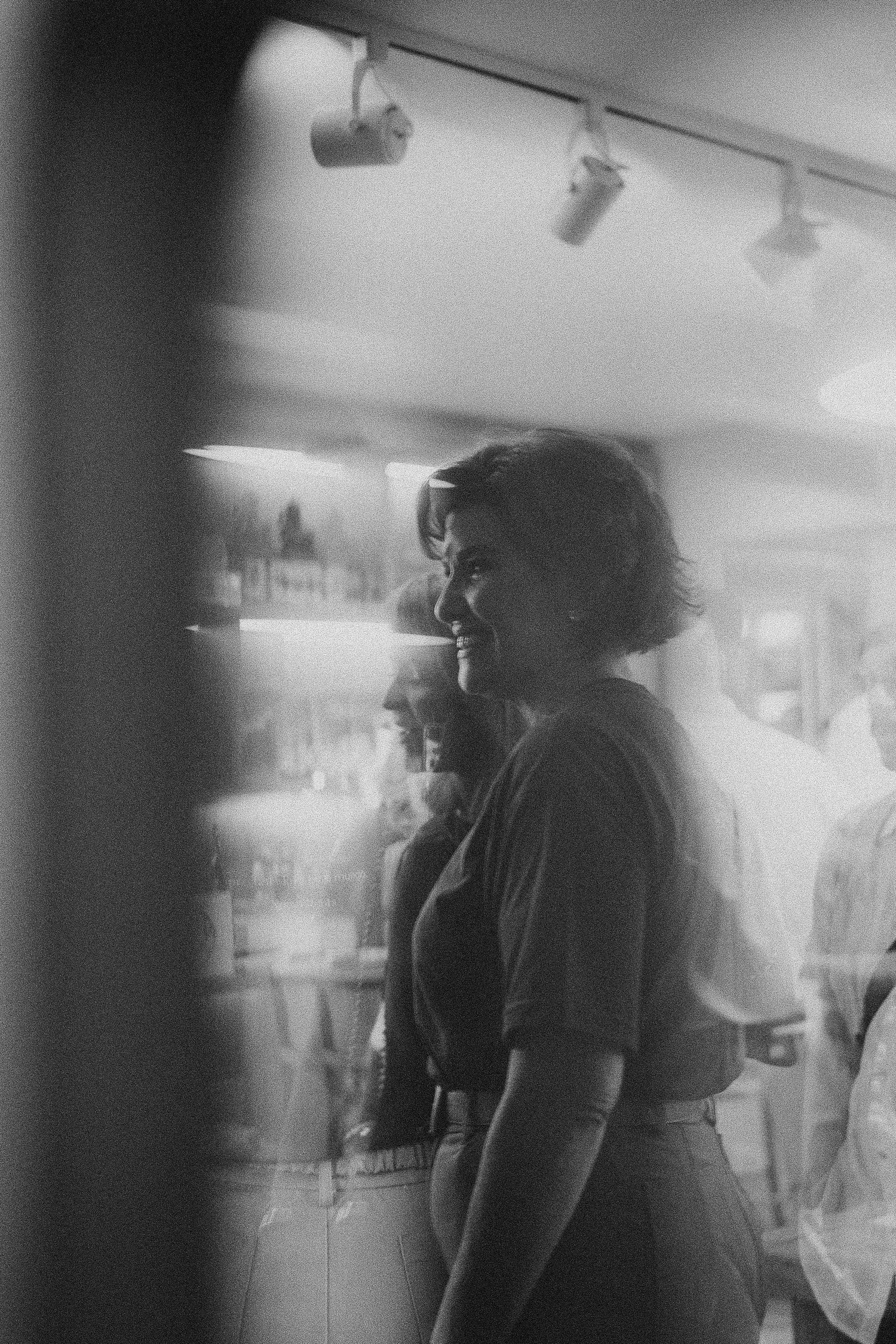 Black and white photo of silhouettes moving through indoor space.