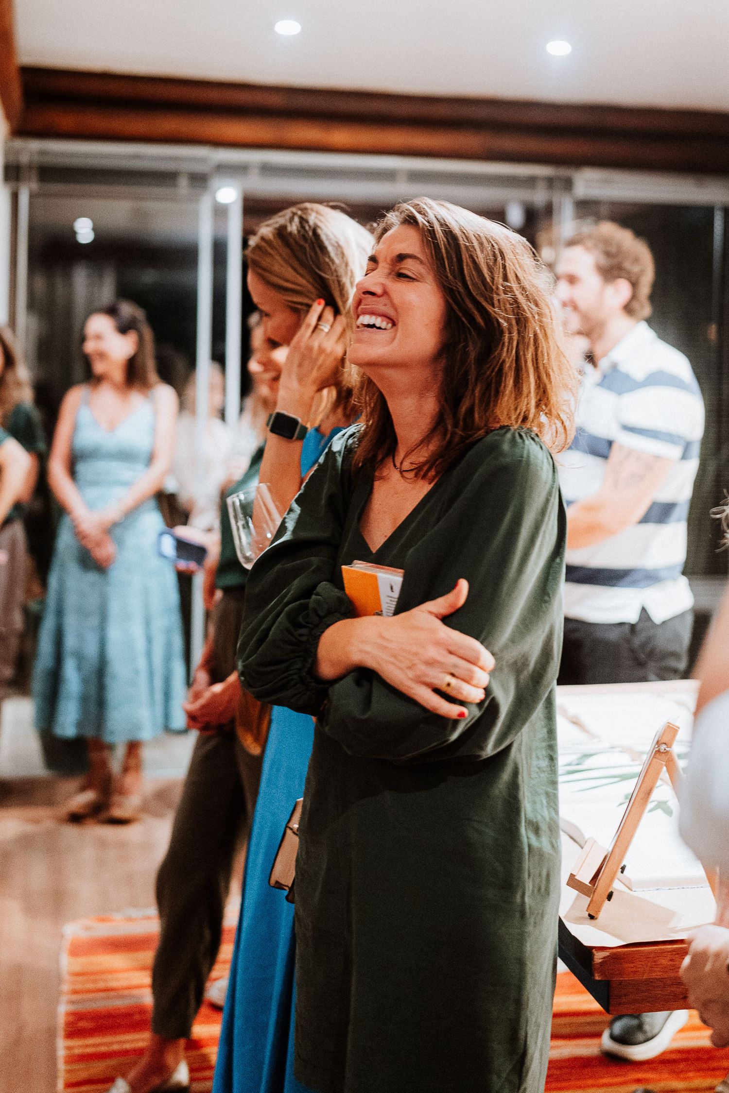 People enjoying a lively social gathering with joyful expressions and laughter.