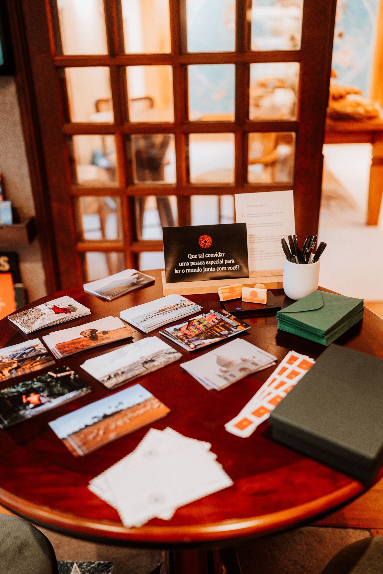 Table display of photos and marketing materials in a warm-lit interior setting.