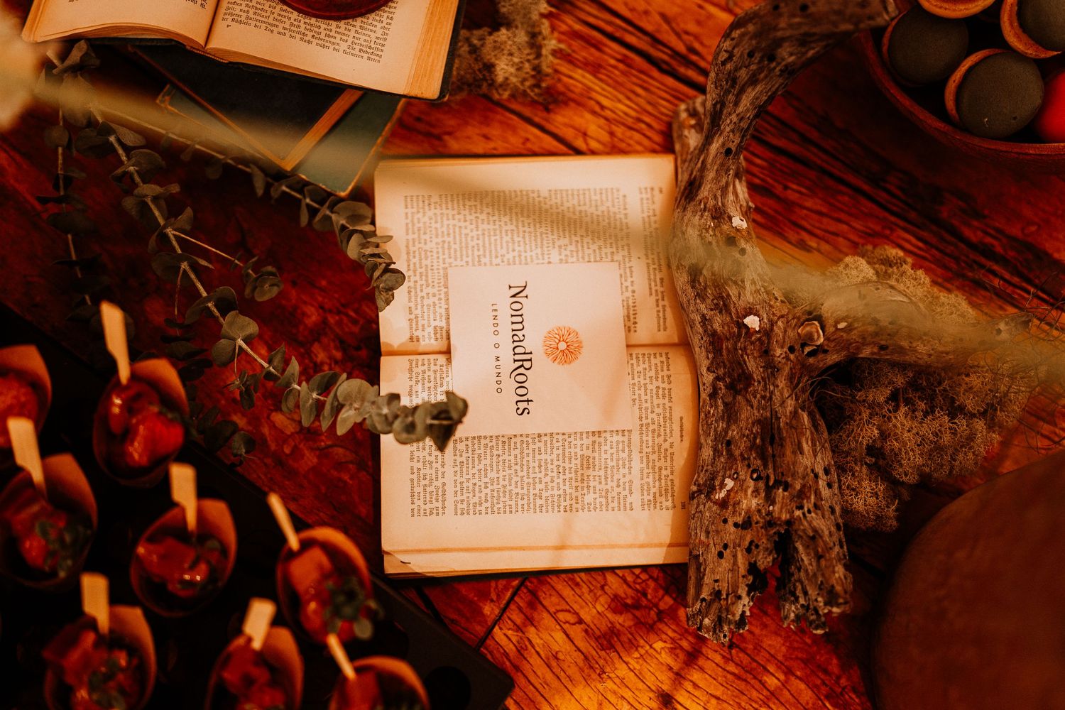 Vintage style photograph of postcards and dried flowers in warm lighting.