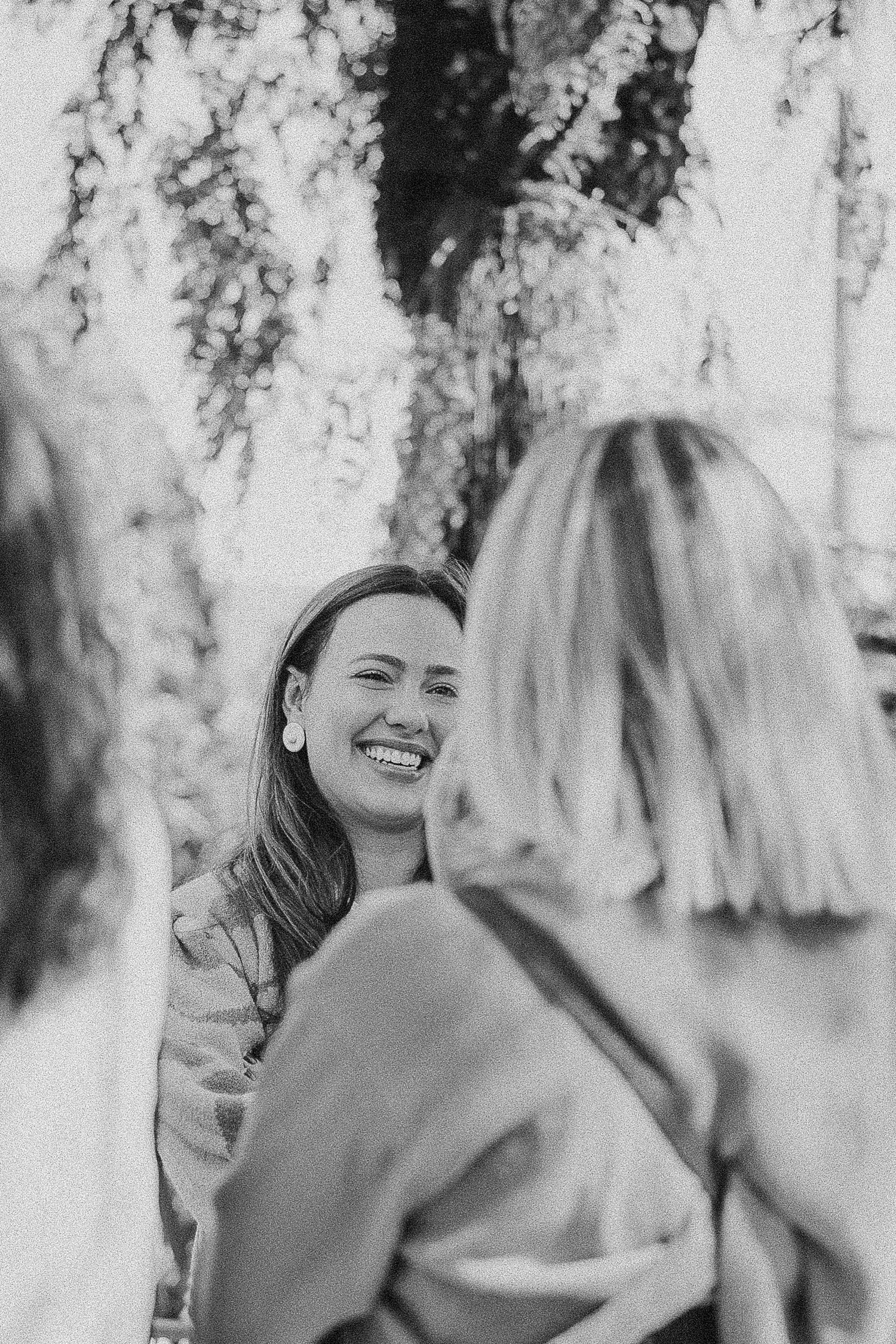 People engaged in conversation outdoors with natural lighting.