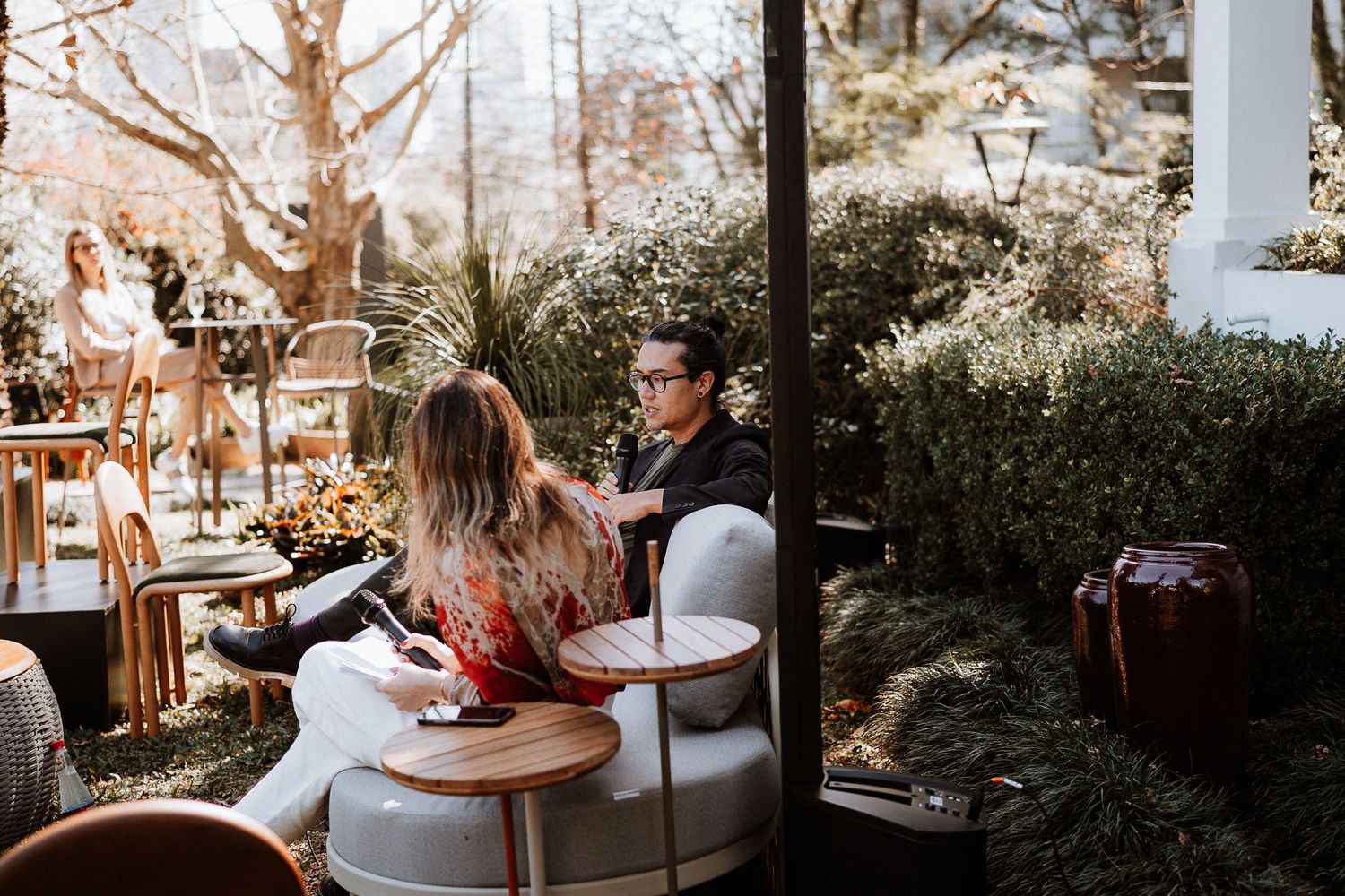 Guests enjoying conversation at an outdoor garden party setting.