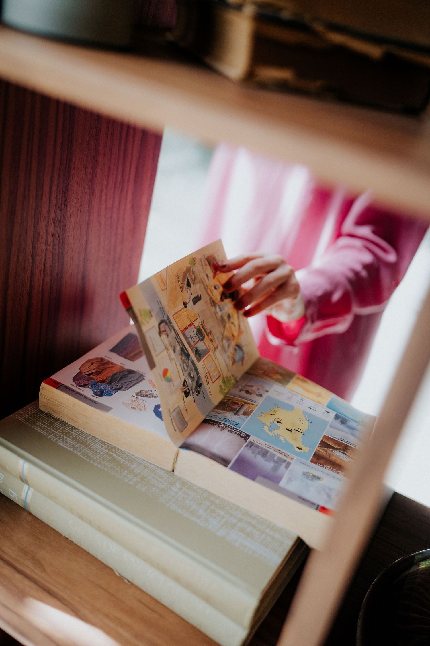 Close-up shot of hands flipping through pages of magazine or photo book.