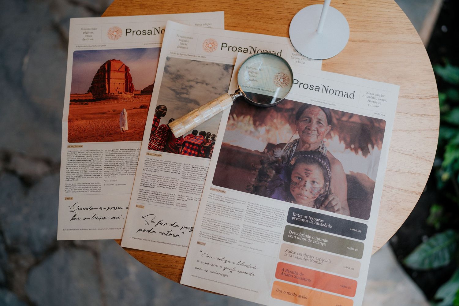 Collection of newspapers and press materials spread out on a wooden surface.