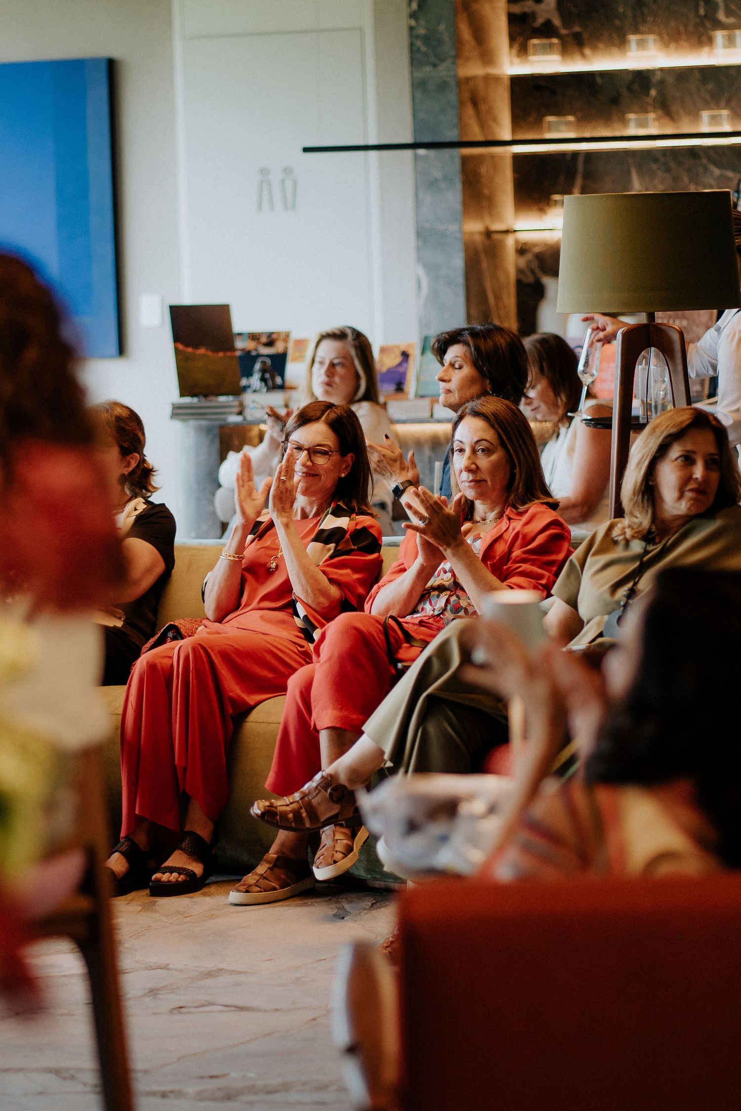 A group wearing red outfits sits together during what appears to be a casual gathering.