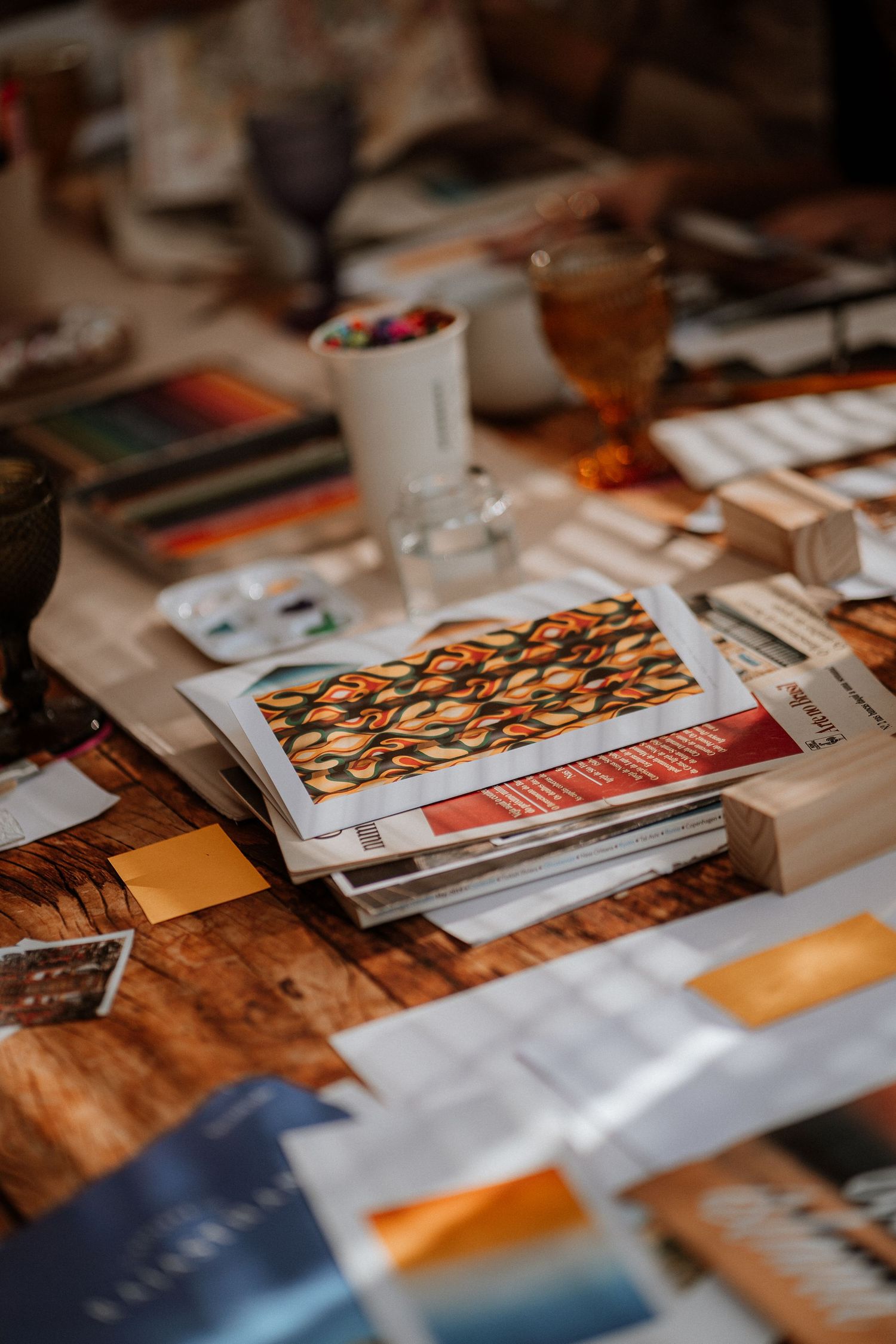 Close-up of printed materials and documents spread across a wooden surface.