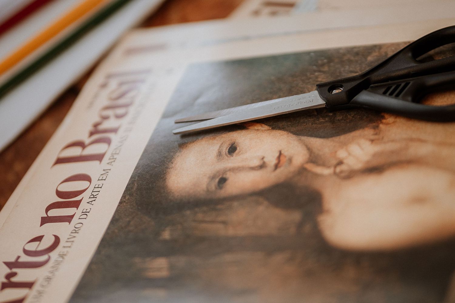 Printed photographs and documents laid out on a wooden table surface.