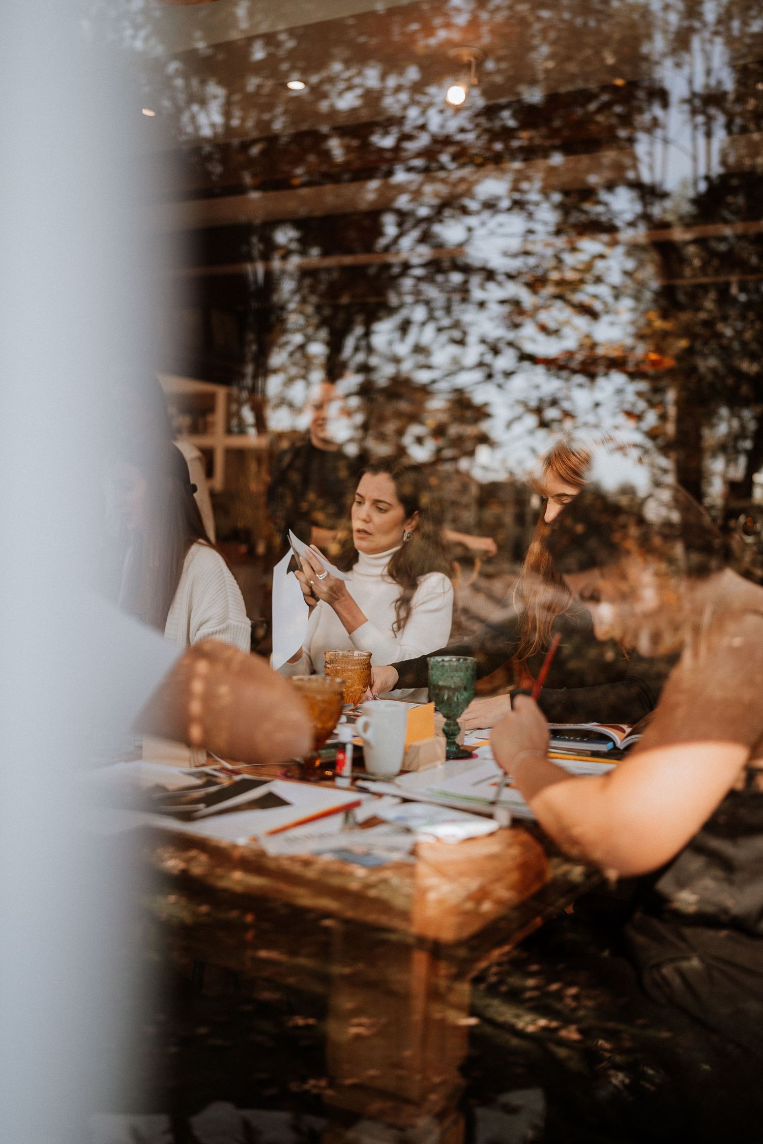 Cozy autumn gathering at a wooden table outdoors during sunset.
