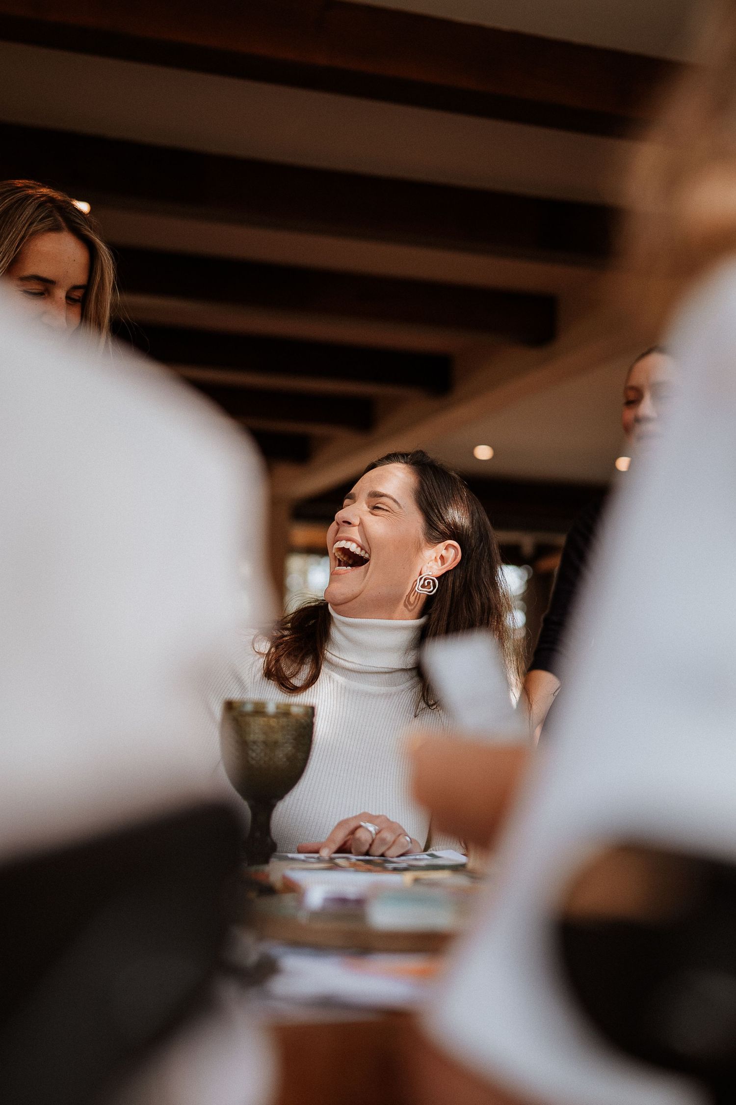 Joyful moment captured during a creative gathering in a warm-lit indoor space.