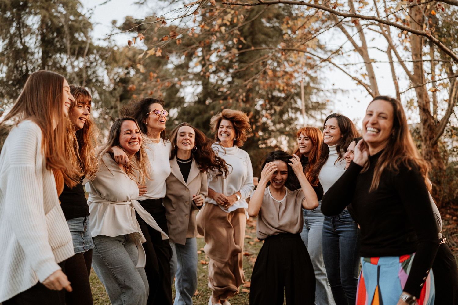 Candid shot of friends sharing laughter and joy during a casual outdoor gathering.