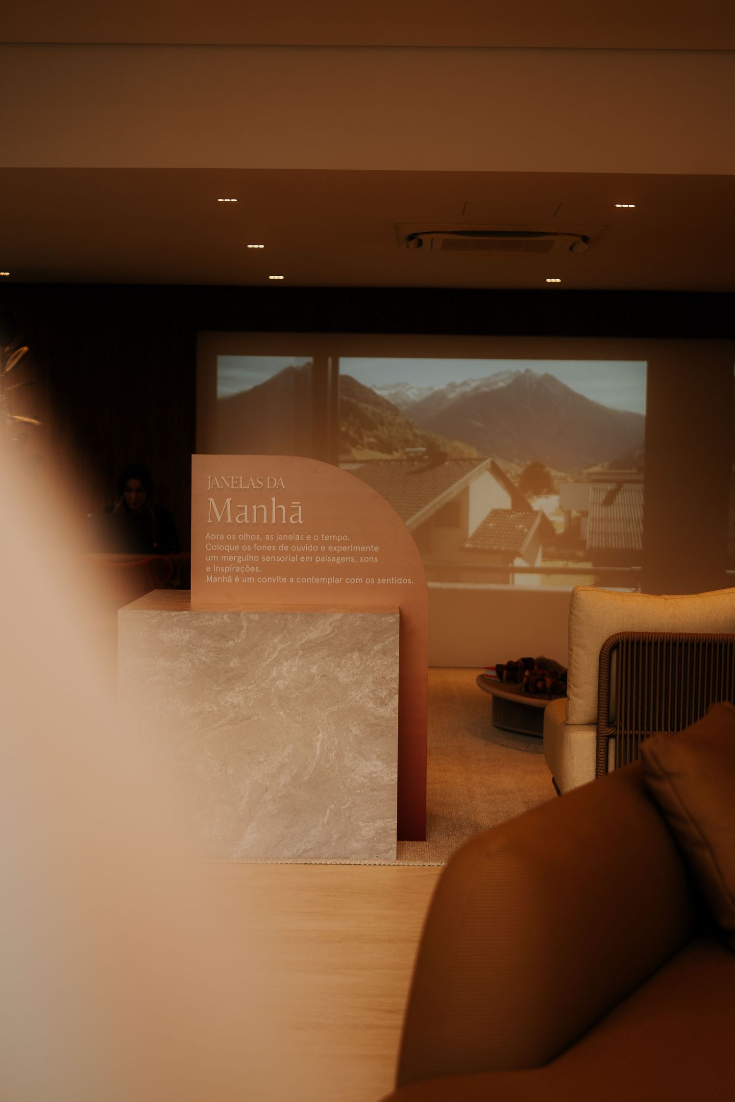 Presentation screen displaying content in a modern conference room with comfortable seating.