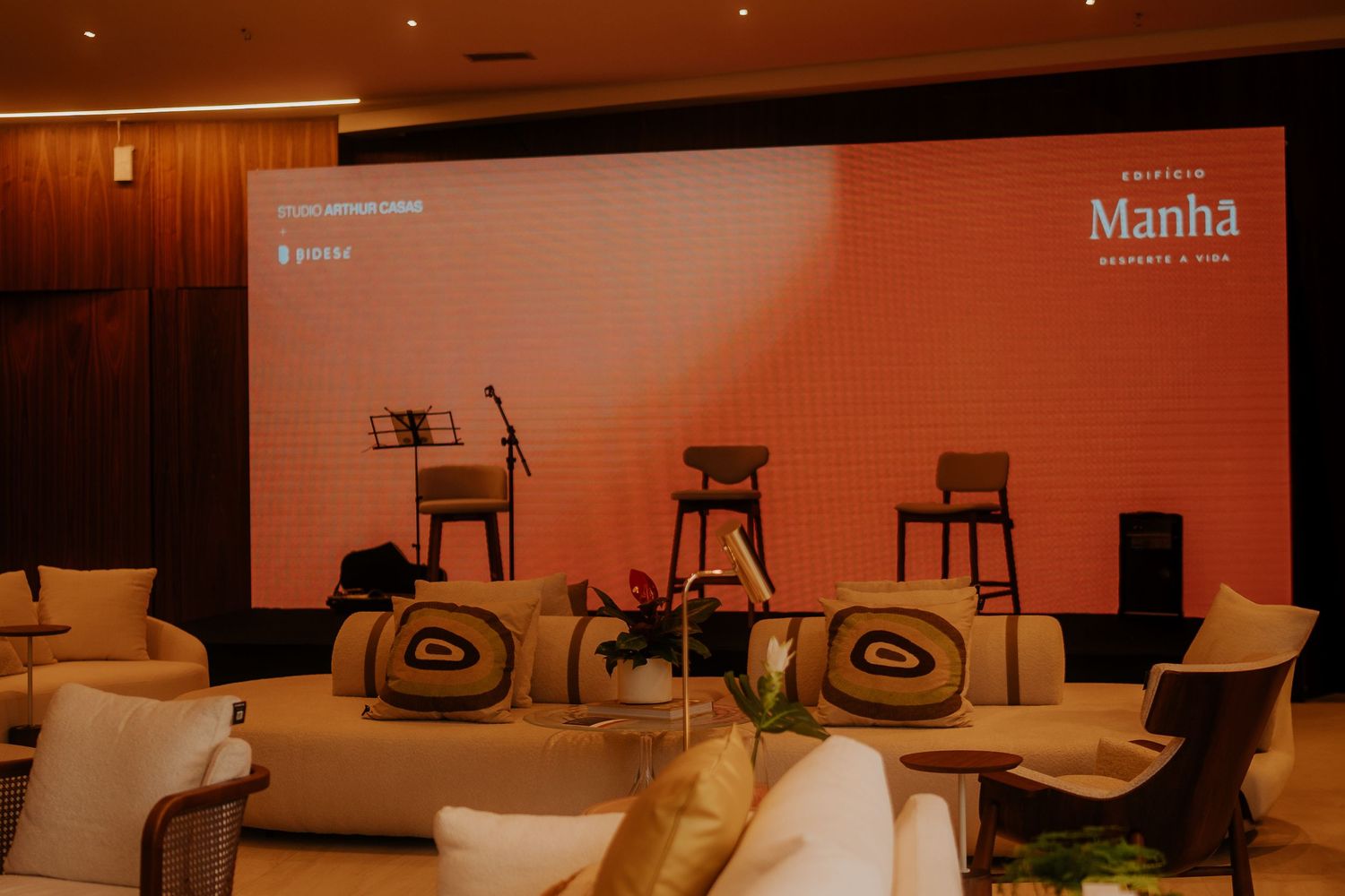 Conference room setup with presentation screen and comfortable seating arrangements.