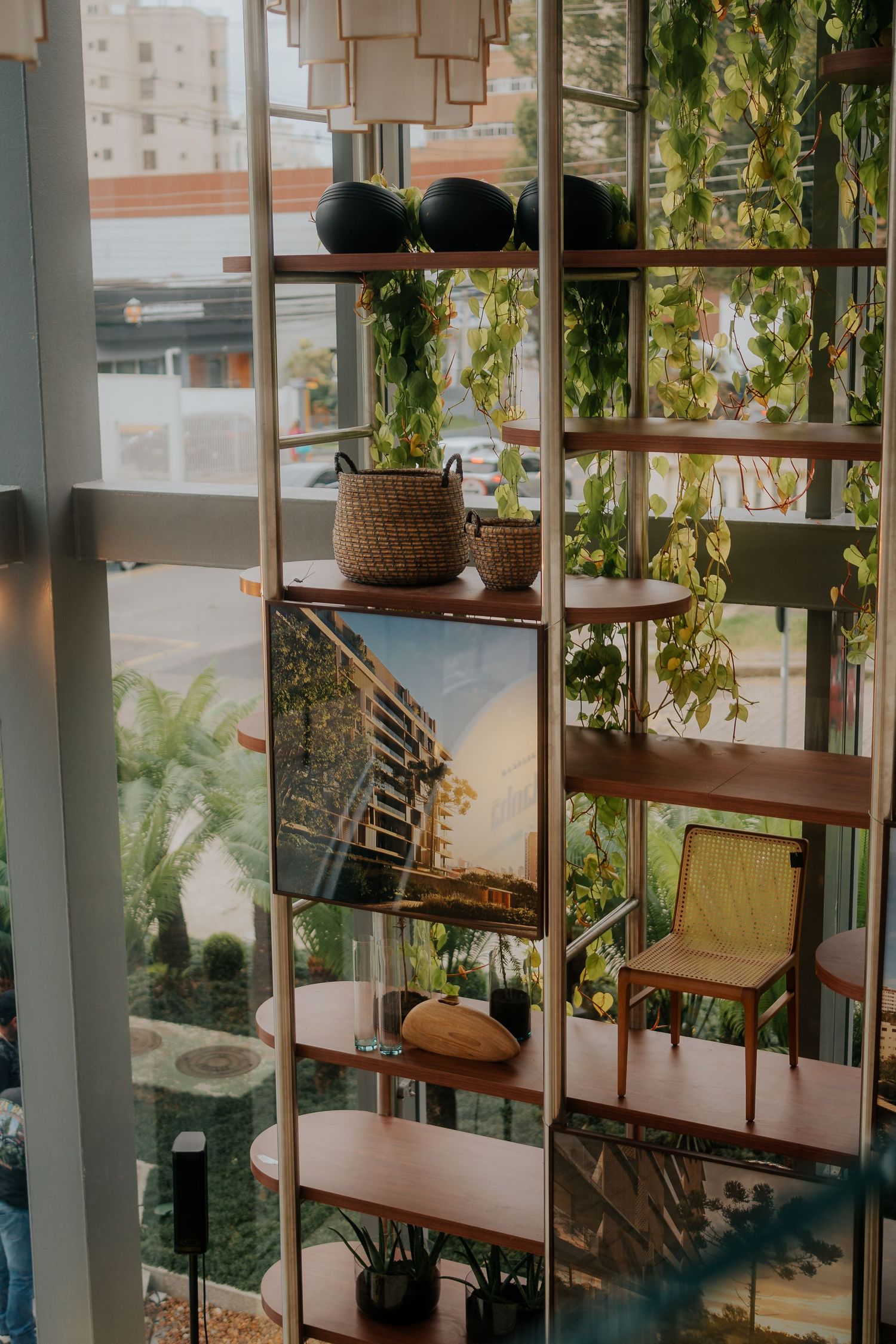 Contemporary office interior with wooden shelving units and abundant natural light.