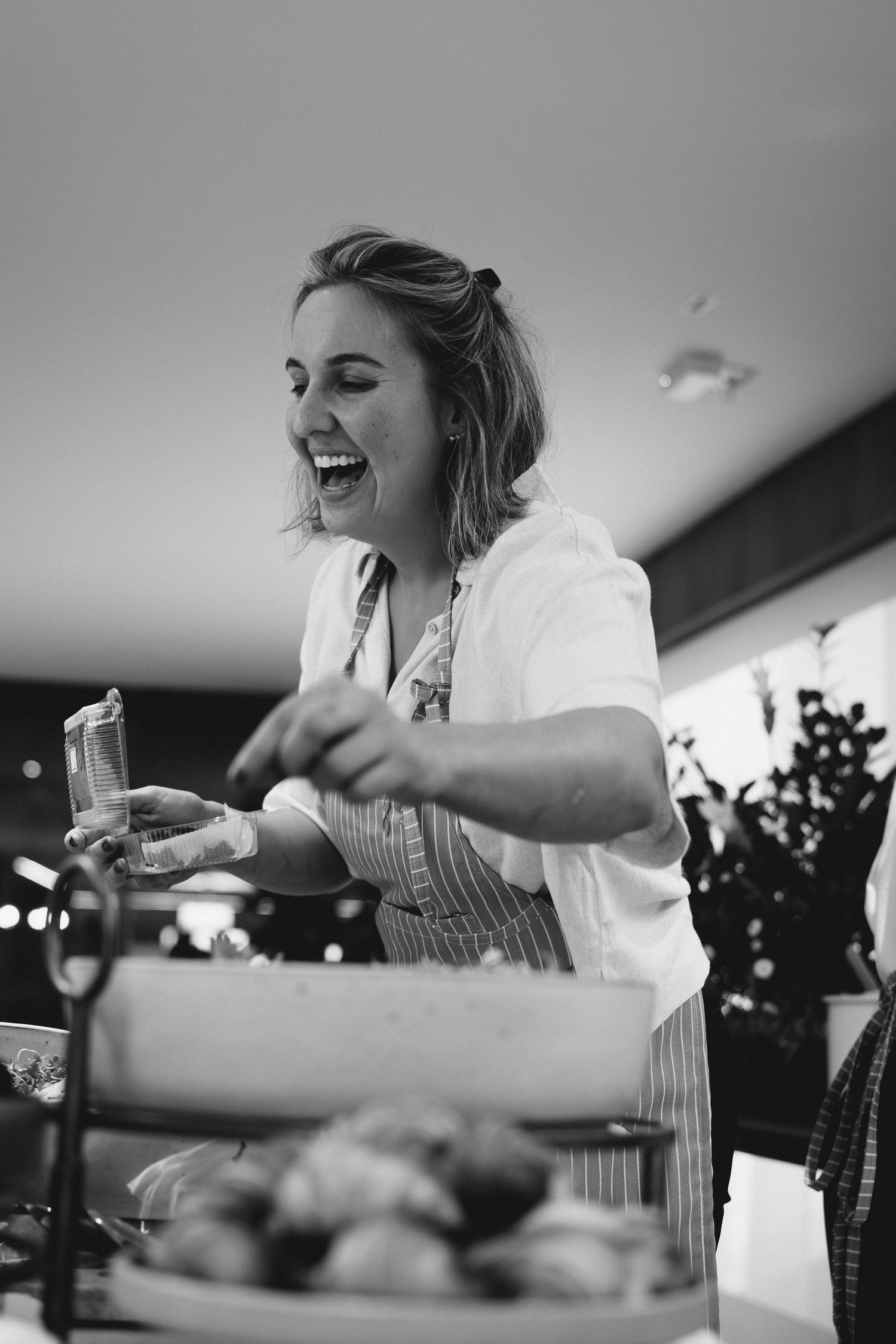 Kitchen staff member preparing food with enthusiasm during service.