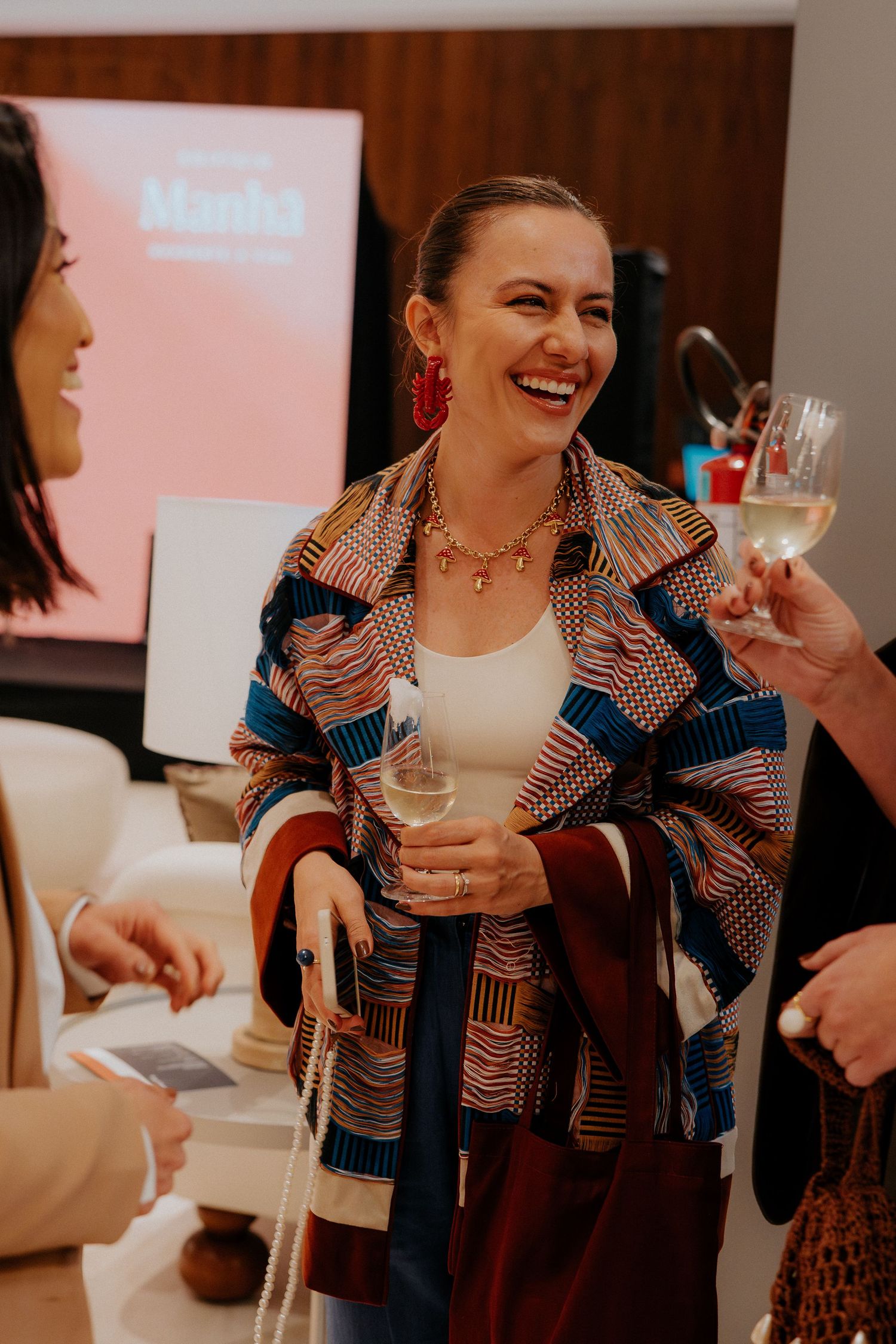 A social gathering with wine glasses and festive atmosphere.