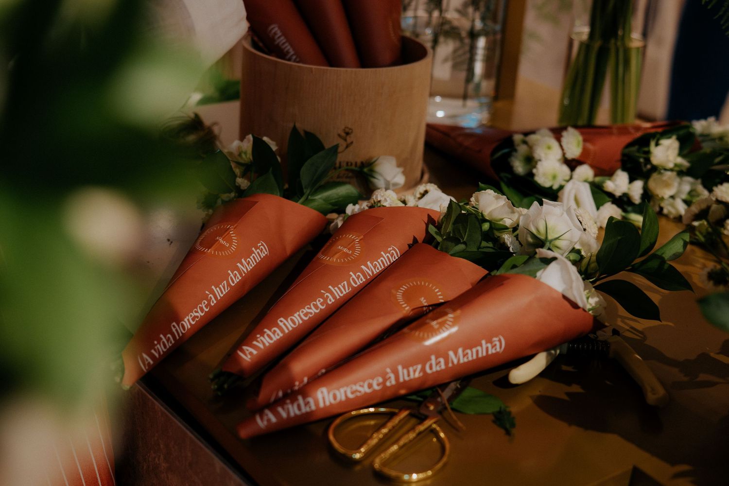Brown paper scrolls with text arranged with white flowers for decoration.