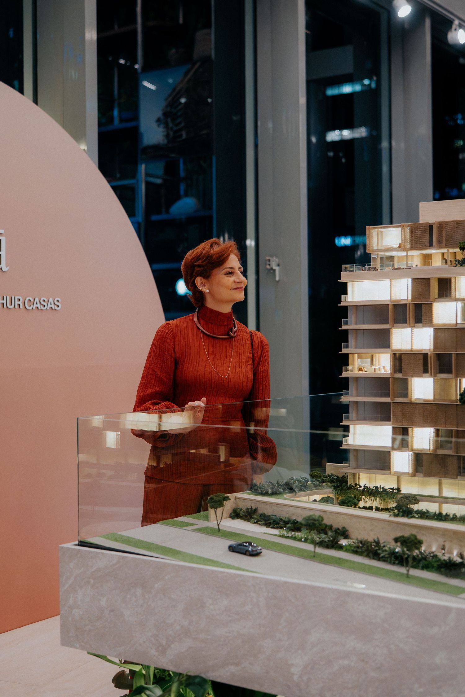 Architectural scale model of a modern building development with illuminated details.