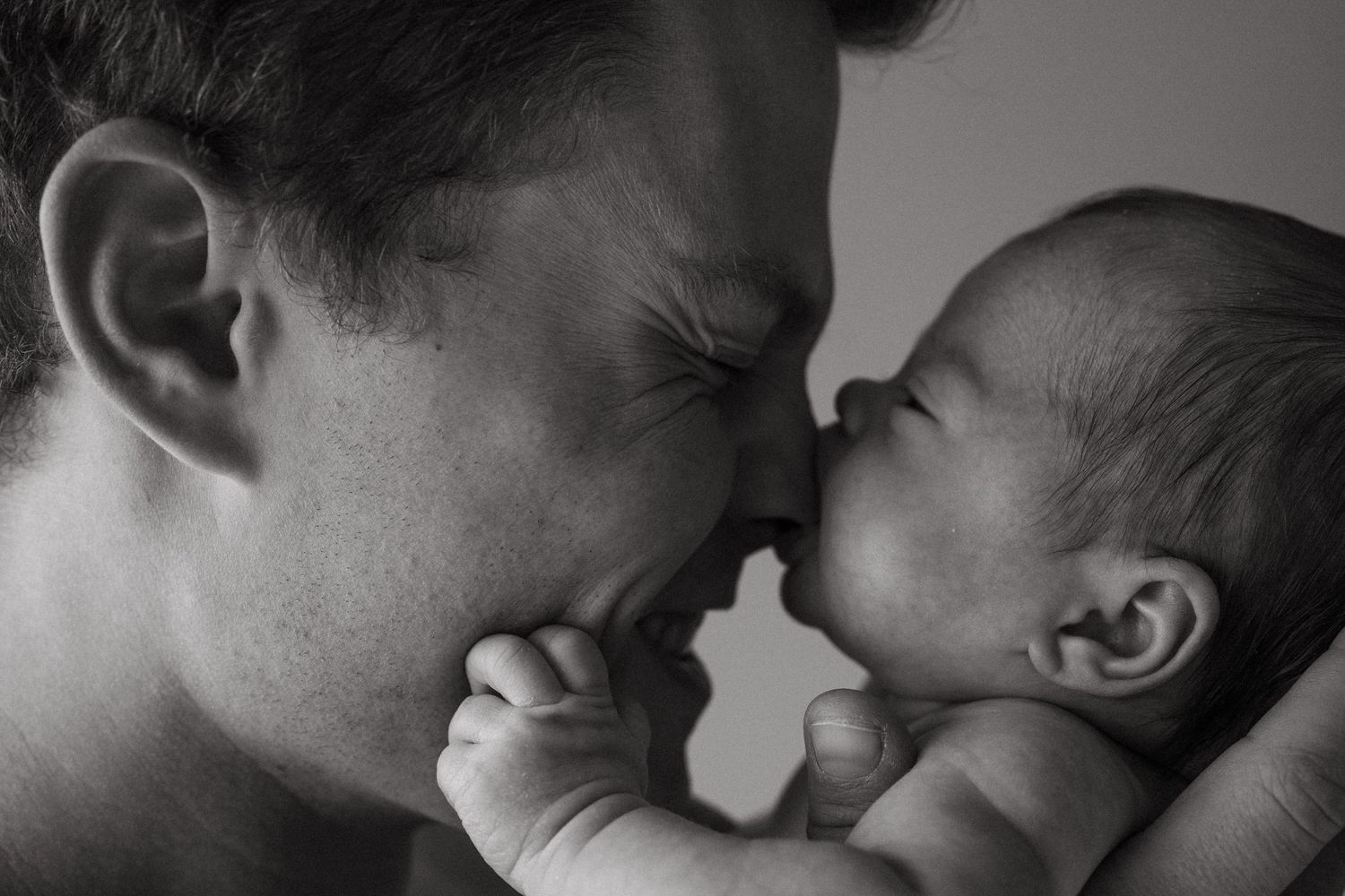 Black and white close-up photos showing tender family moments.
