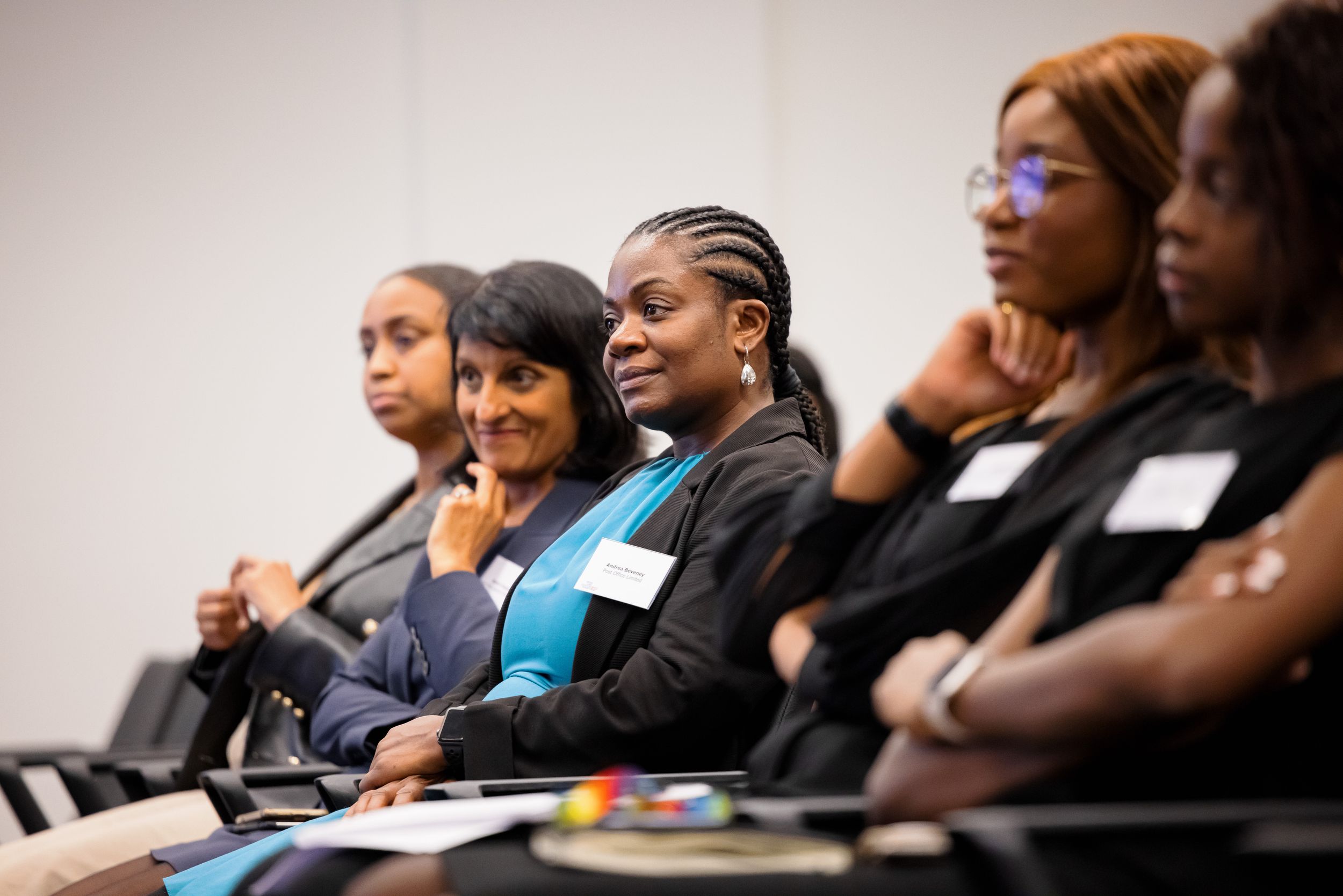 Row of attendees seated in a conference room during a professional presentation.