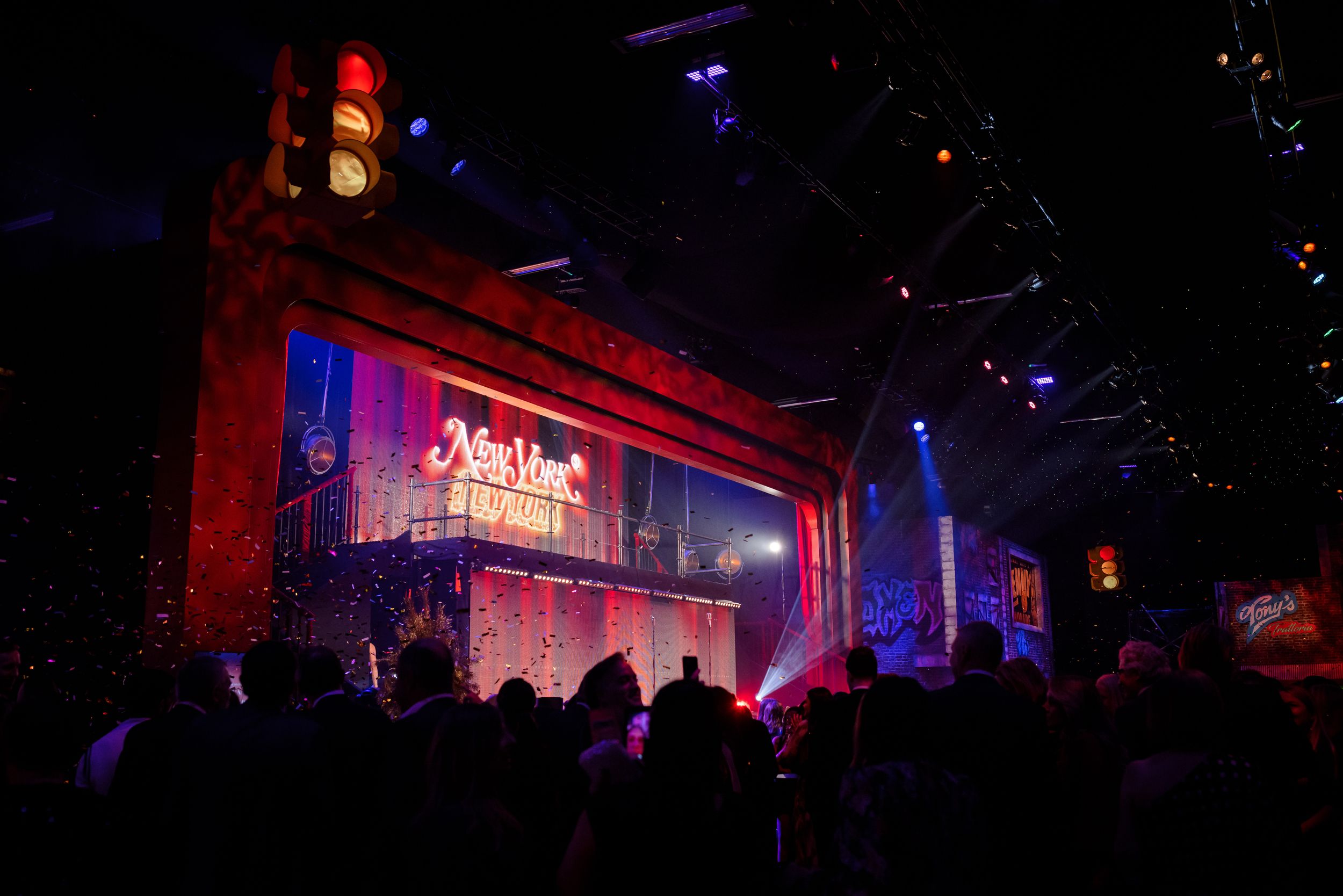 Concert venue illuminated with red and blue lighting creating an atmospheric ambiance.