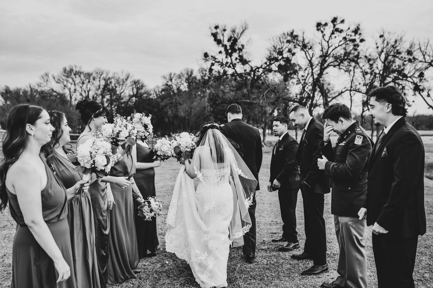 Candid wedding party laughing together during fun group photos at Lucky Spur Ranch.