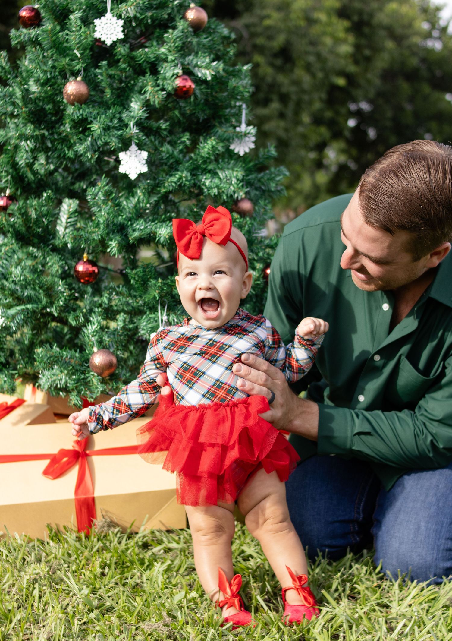dad looking ay daughter outdoor christmas photo