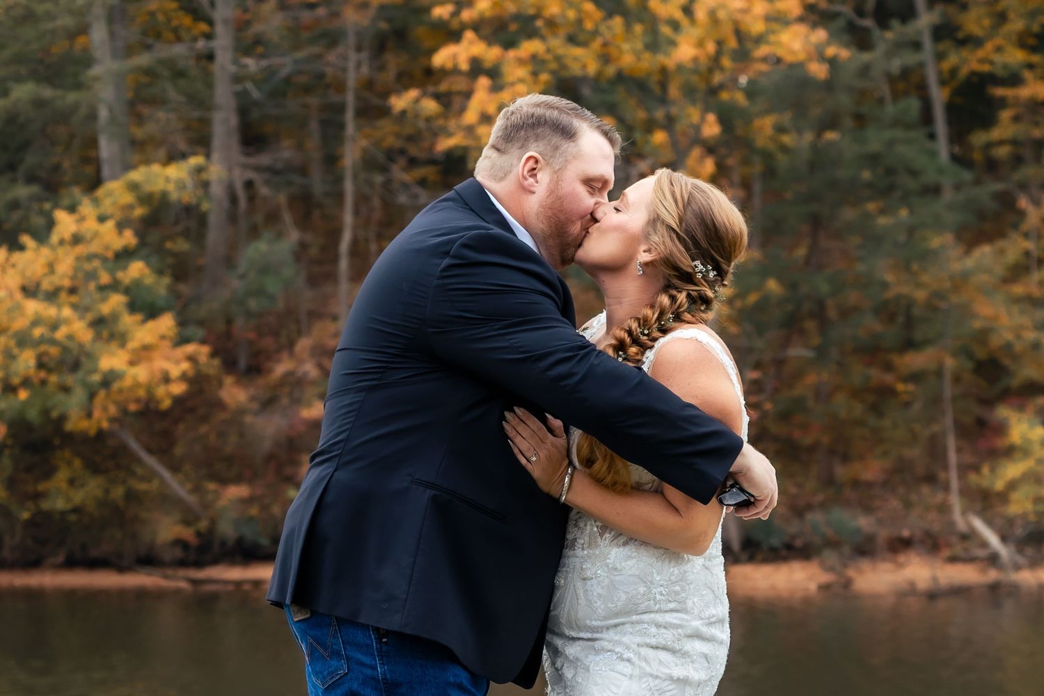 Romantic autumn wedding photos showing couple embracing among fall foliage at The Waterfront in Pasadena, MD. Annapolis wedding photographer