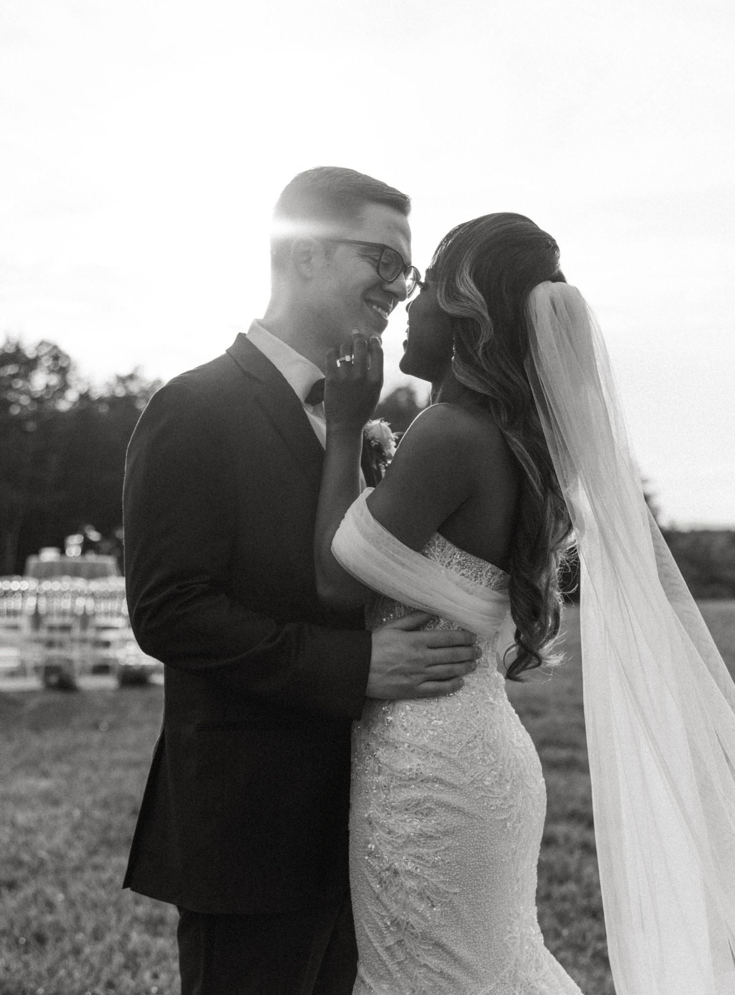 A tender black and white wedding moment captured in natural sunlight.