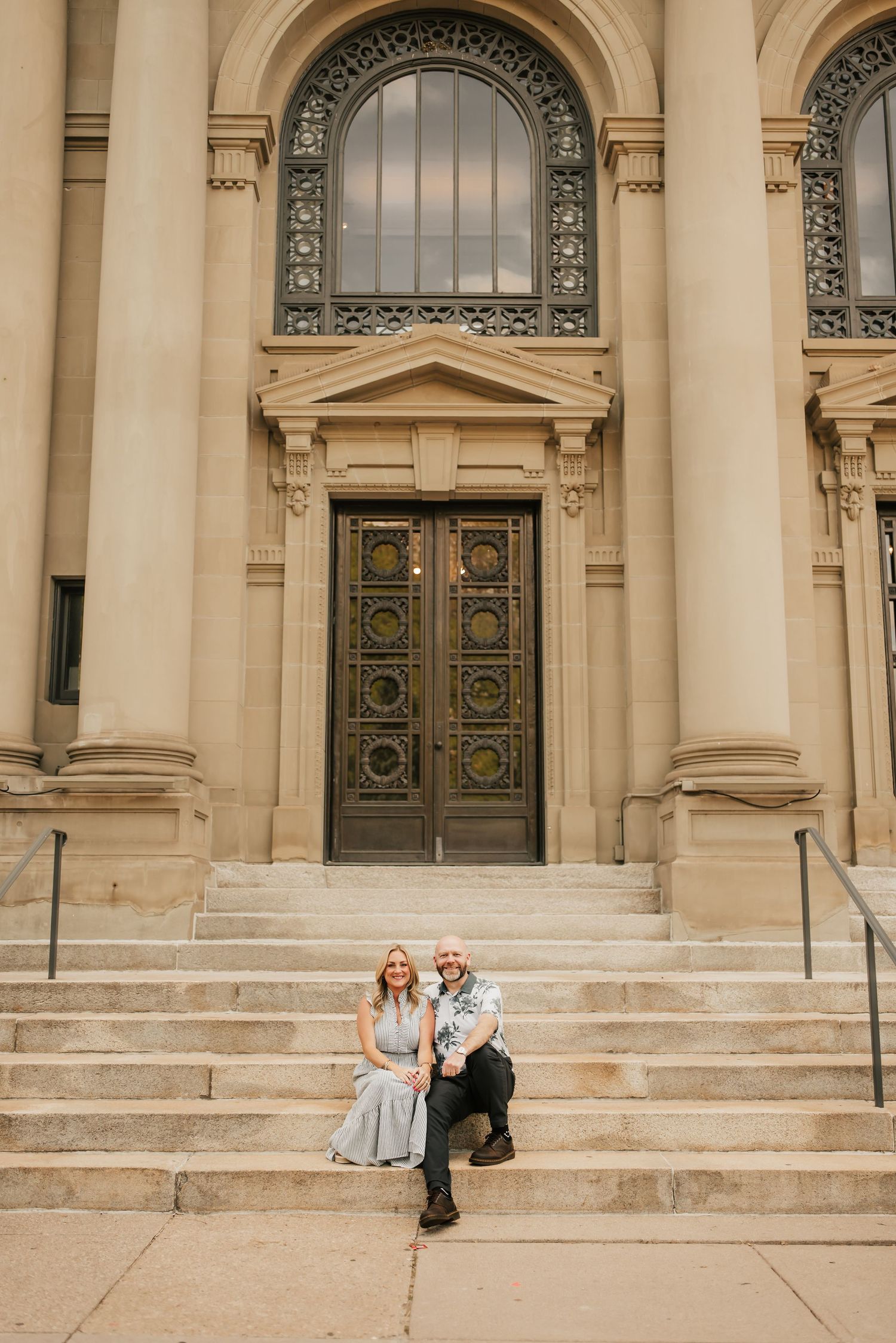 Beautiful couple snuggles up on the streets of downtown Cincinnati.